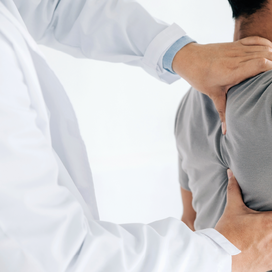 Image of physiotherapist working on male patient's shoulder